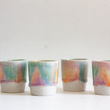 handmade ceramic espresso cup glazed in green, purple, peach
