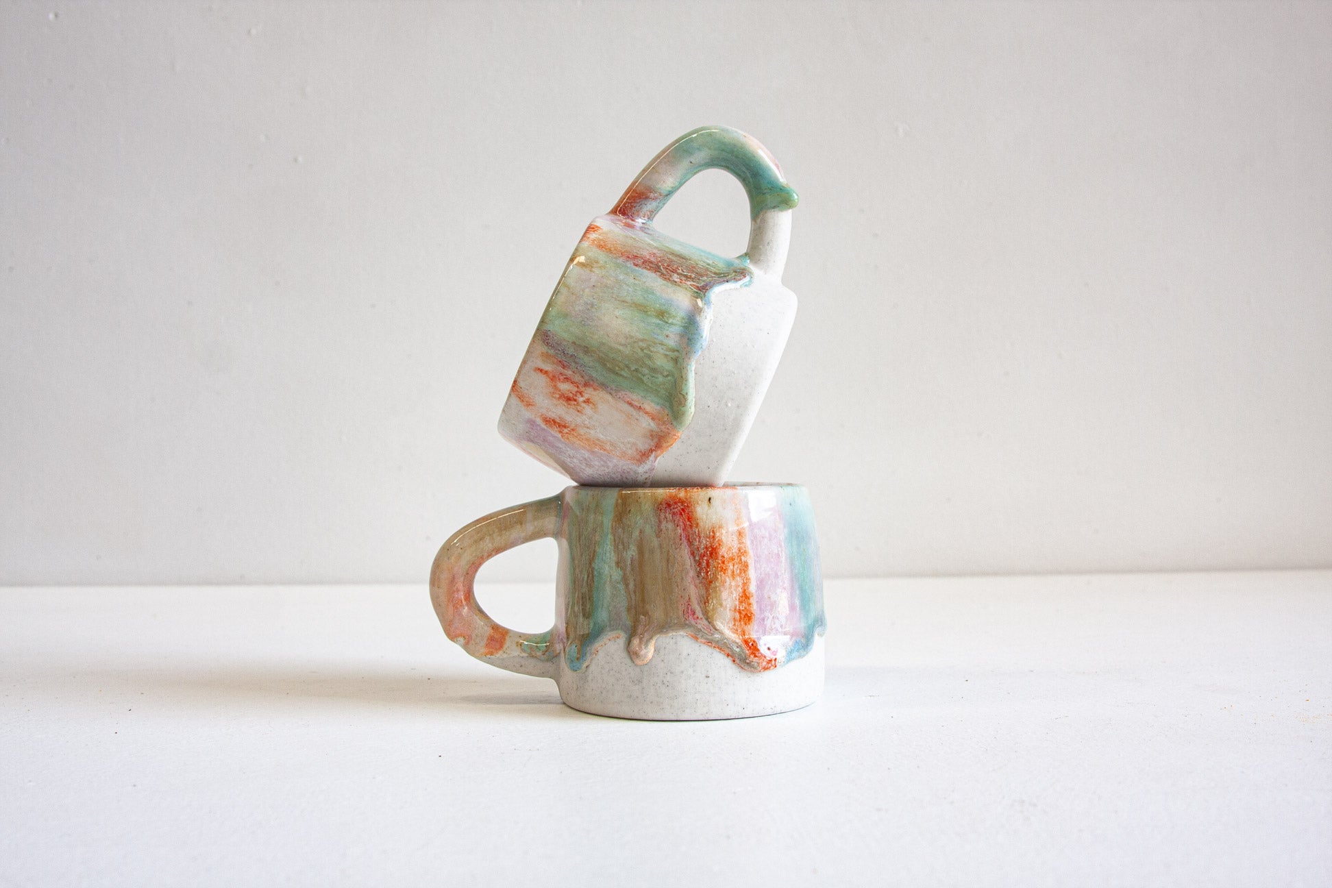 handmade ceramic green, orange, purple and brown mug