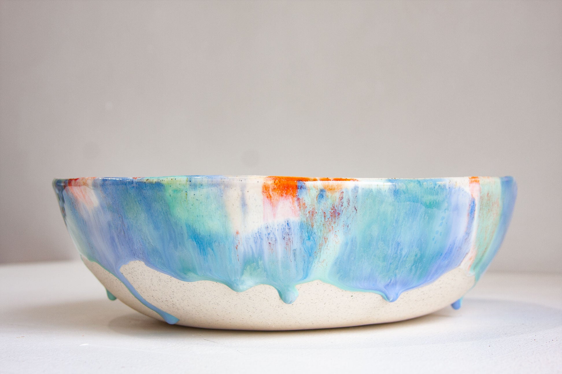 handmade ceramic blue, green, orange and white fruit bowl