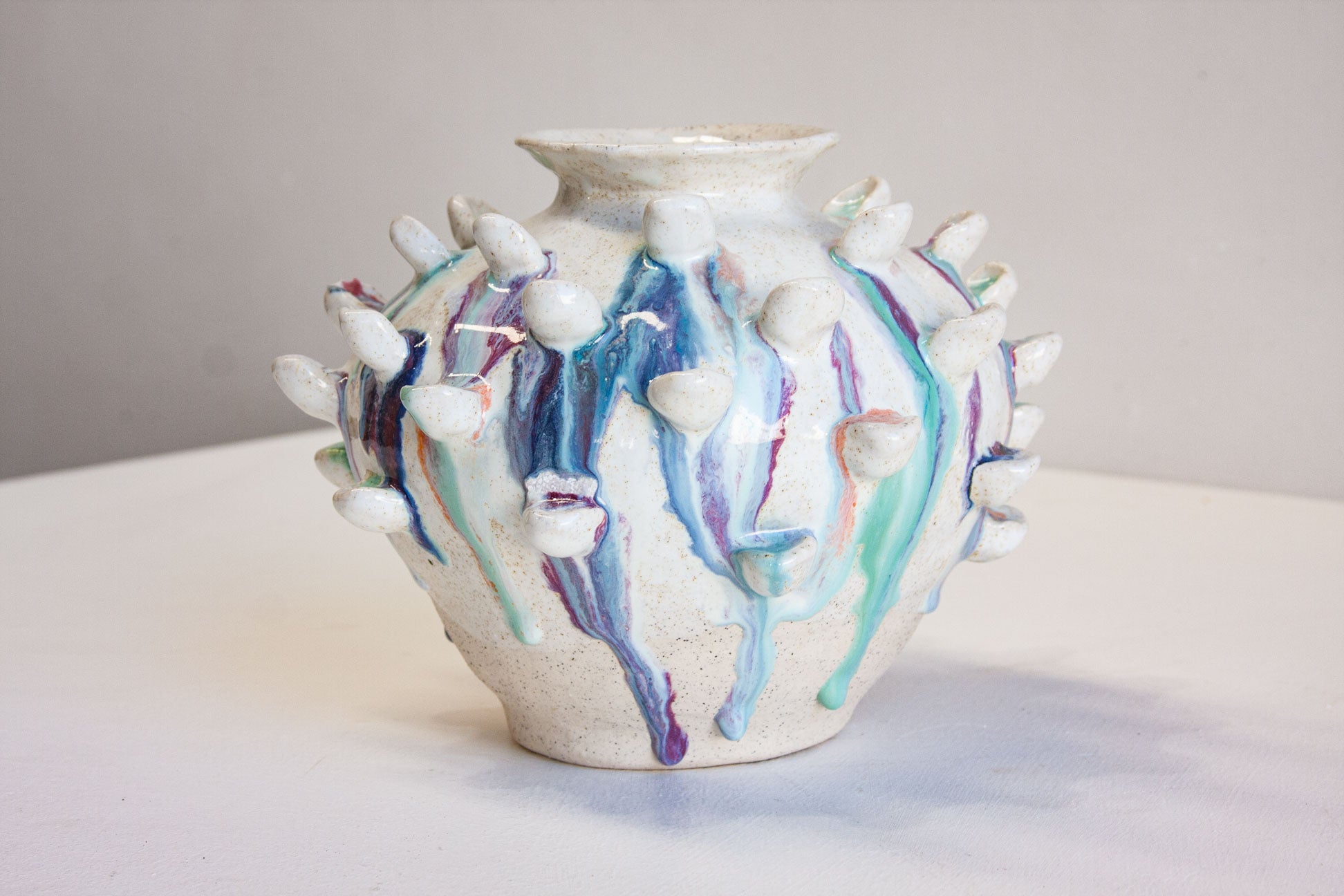 handmade sculptural vase with petal like attachments, multicoloured