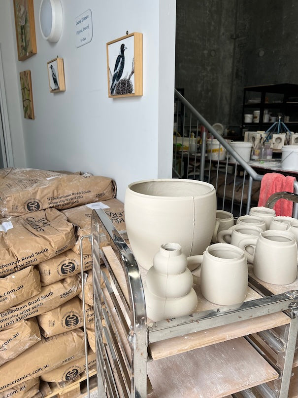 freshly slipcasted pieces drying next to a pile of slip casting clay powder