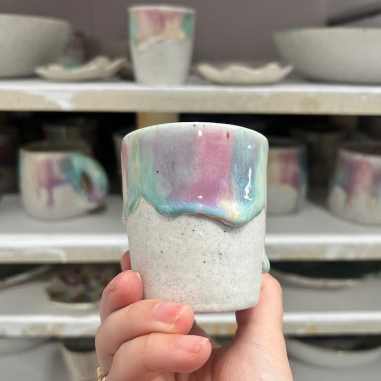 Bright cone 6 stoneware espresso cups in vivid turquoise and pink glazes cooling inside an electric kiln