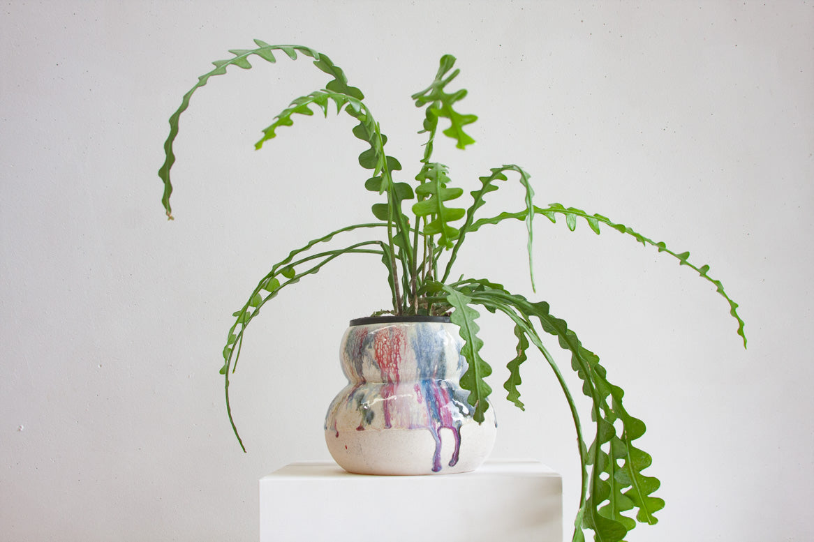 handmade ceramic rounded planter, glazed in ruby reds and deep blues.