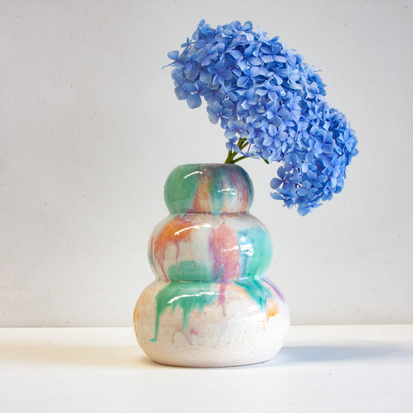 Handmade ceramic green, peach, purple and white sculptural vase with blue hydrangea