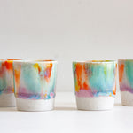 handmade ceramic espresso cup glazed in purple, green, yellow and orange