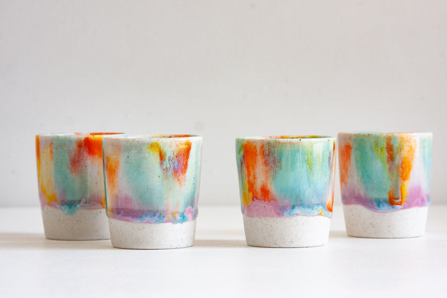 handmade ceramic espresso cup glazed in purple, green, yellow and orange