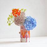 Vase with decorative clay ball glazed in orange and purple