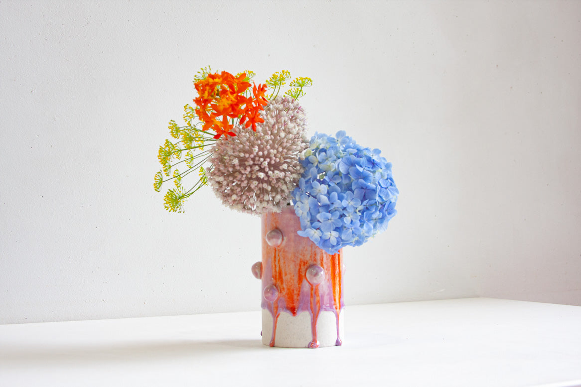 Vase with decorative clay ball glazed in orange and purple