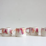handmade ceramic mug glazed in pinks, peach, white and brown