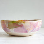Ceramic bowl with abstract multicolor design on a white clay