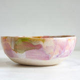 Ceramic bowl with abstract multicolor design on a white clay