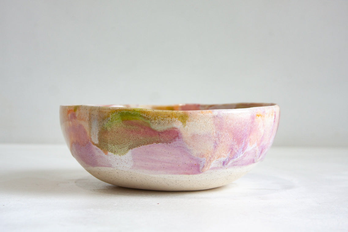 Ceramic bowl with abstract multicolor design on a white clay