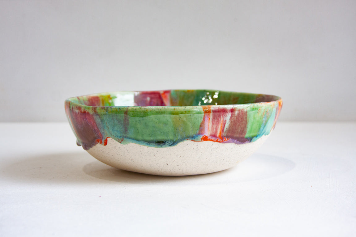 Ceramic bowl with multicolored glaze on a white clay body 