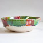 Ceramic bowl with multicolored glaze on a white clay body 