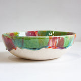 Ceramic bowl with multicolored glaze on a white clay body 