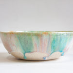 Ceramic bowl with multicolored glaze on a white clay body