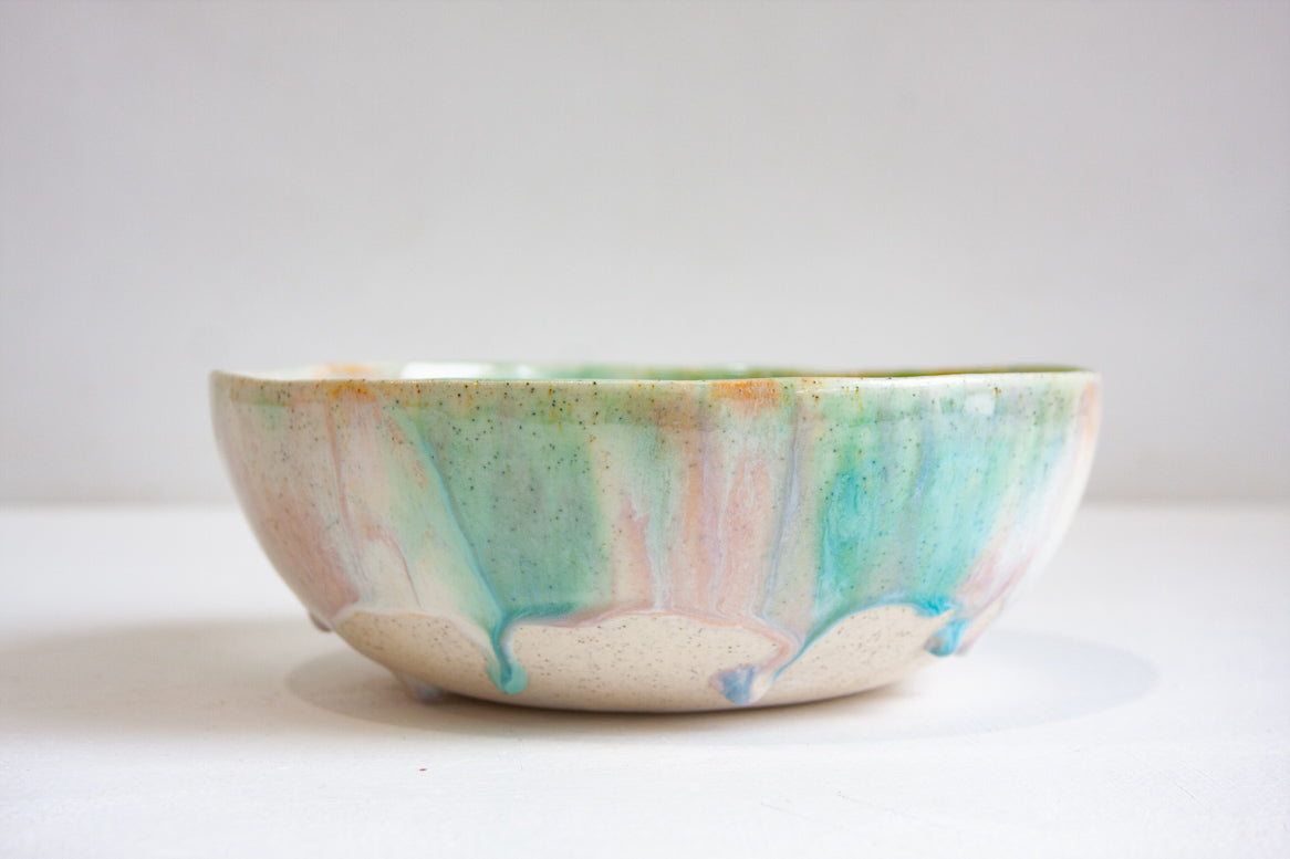 Ceramic bowl with multicolored glaze on a white clay body