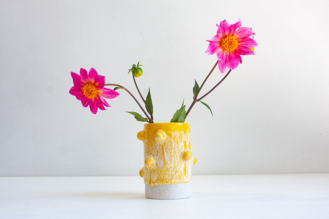 handmade ceramic yellow cylinder vase decorated with clay balls