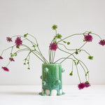 handmade ceramic cylinder vase decorated with small balls glazed in a drippy green glaze