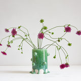 handmade ceramic cylinder vase decorated with small balls glazed in a drippy green glaze