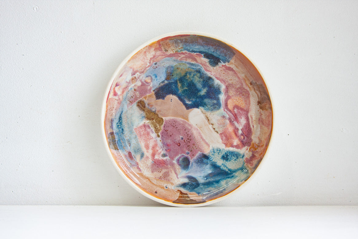 handmade ceramic deep plate glazed in blue, brown and pink