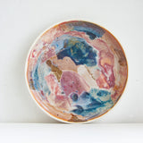 handmade ceramic deep plate glazed in blue, brown and pink