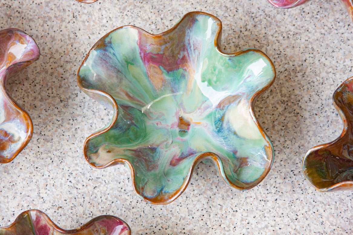 handmade ceramic dark clay oyster shaped bowl glazed in pinks and greens