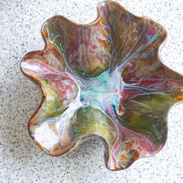 handmade ceramic dark clay oyster shaped bowl glazed in dark green, blue, dark pink and brown
