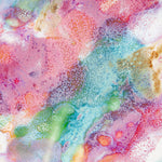 Extreme close-up of the interior glaze surface of a handmade ceramic deep plate showing swirling pink, teal, green, orange and amber paint-pour detail