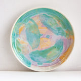 handmade ceramic deep plate glazed in green, purple and peach
