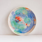 handmade ceramic deep plate glazed in blue, green, light purple and orange