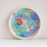 handmade ceramic deep plate glazed in blue, green, light purple and orange