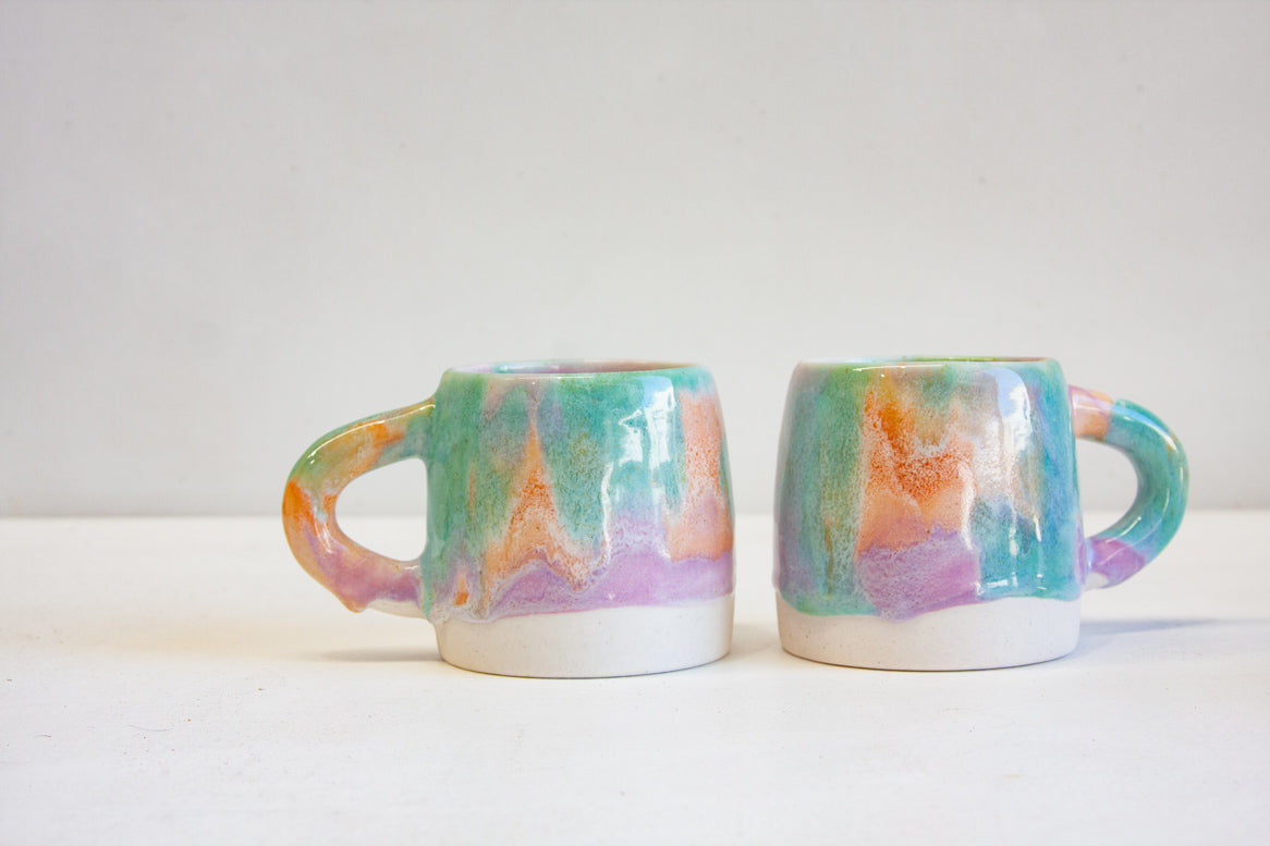photo of two of handmade ceramic purple, green and peach large mugs