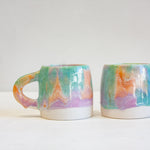 photo of two of handmade ceramic purple, green and peach large mugs