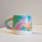 photo of handmade ceramic purple, green and peach close up.
