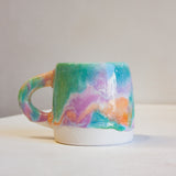 photo of handmade ceramic purple, green and peach close up.