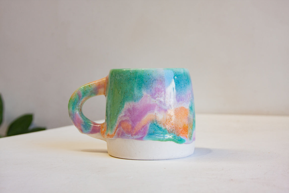 photo of handmade ceramic purple, green and peach close up.
