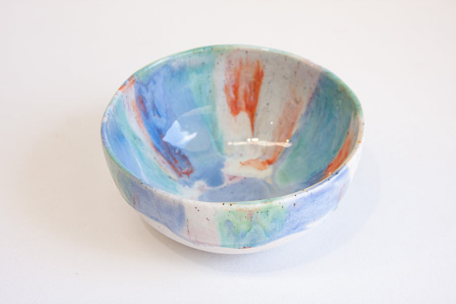 handmade ceramic serving bowl glazed in blue, green, orange and light purple