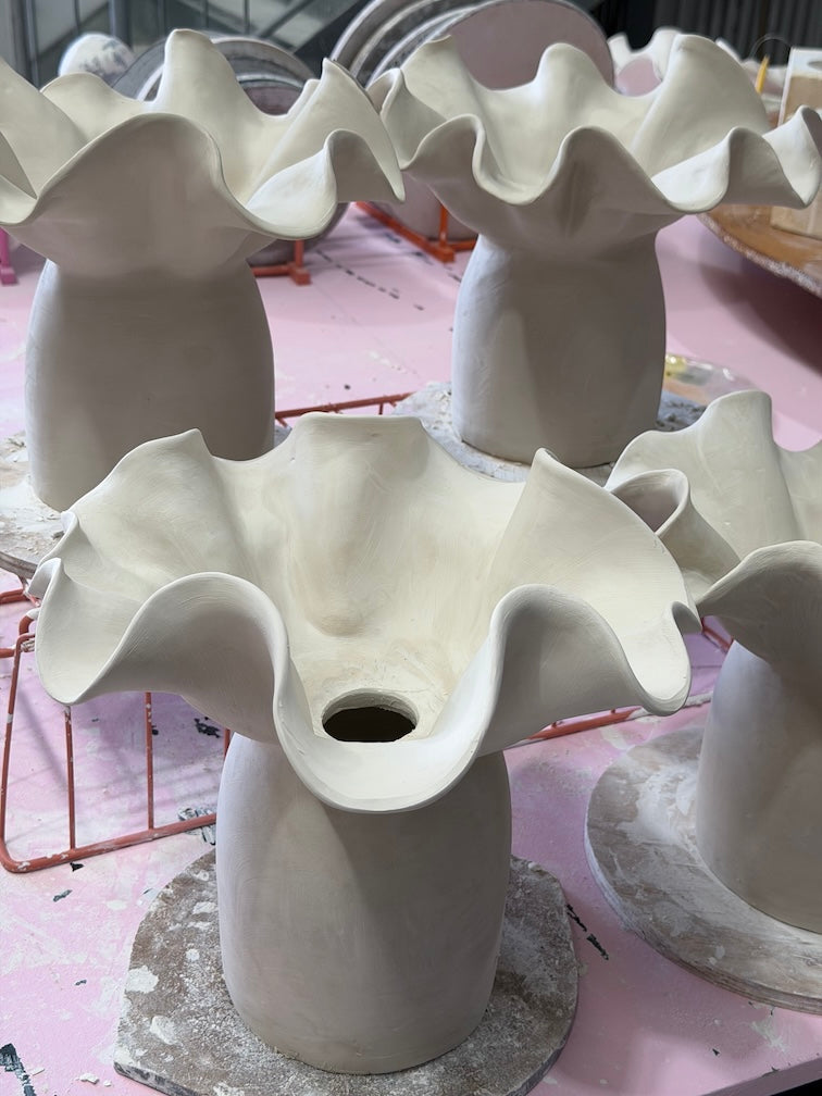 a group of rhiannon gill handmade ceramic table lamps during production in the wollongong studio. It shows the raw clay form before glazing and kiln firing