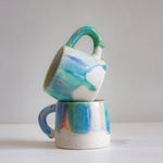 two handmade ceramic blue, green and orange drippy glazed mugs 