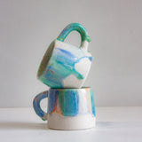 two handmade ceramic blue, green and orange drippy glazed mugs 