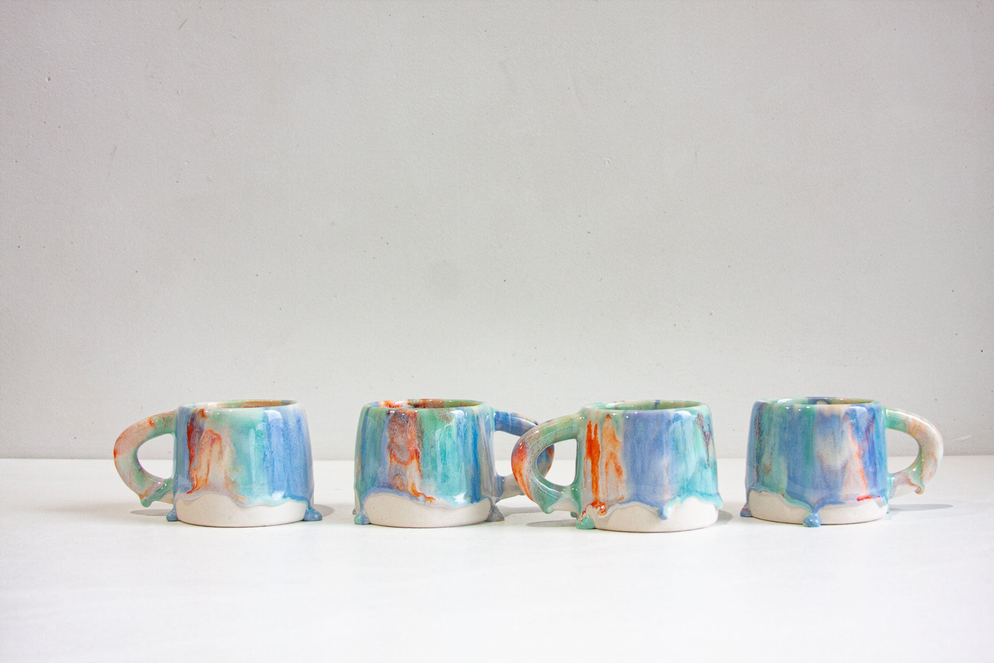 four handmade ceramic drippy glazed mugs