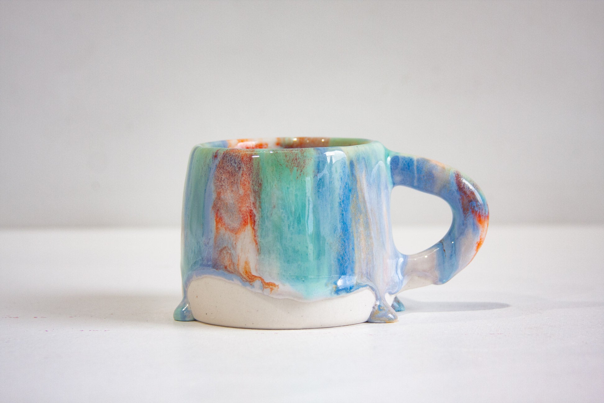 handmade ceramic blue, green, light purple and orange mug