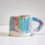 handmade ceramic blue, green, light purple and orange mug