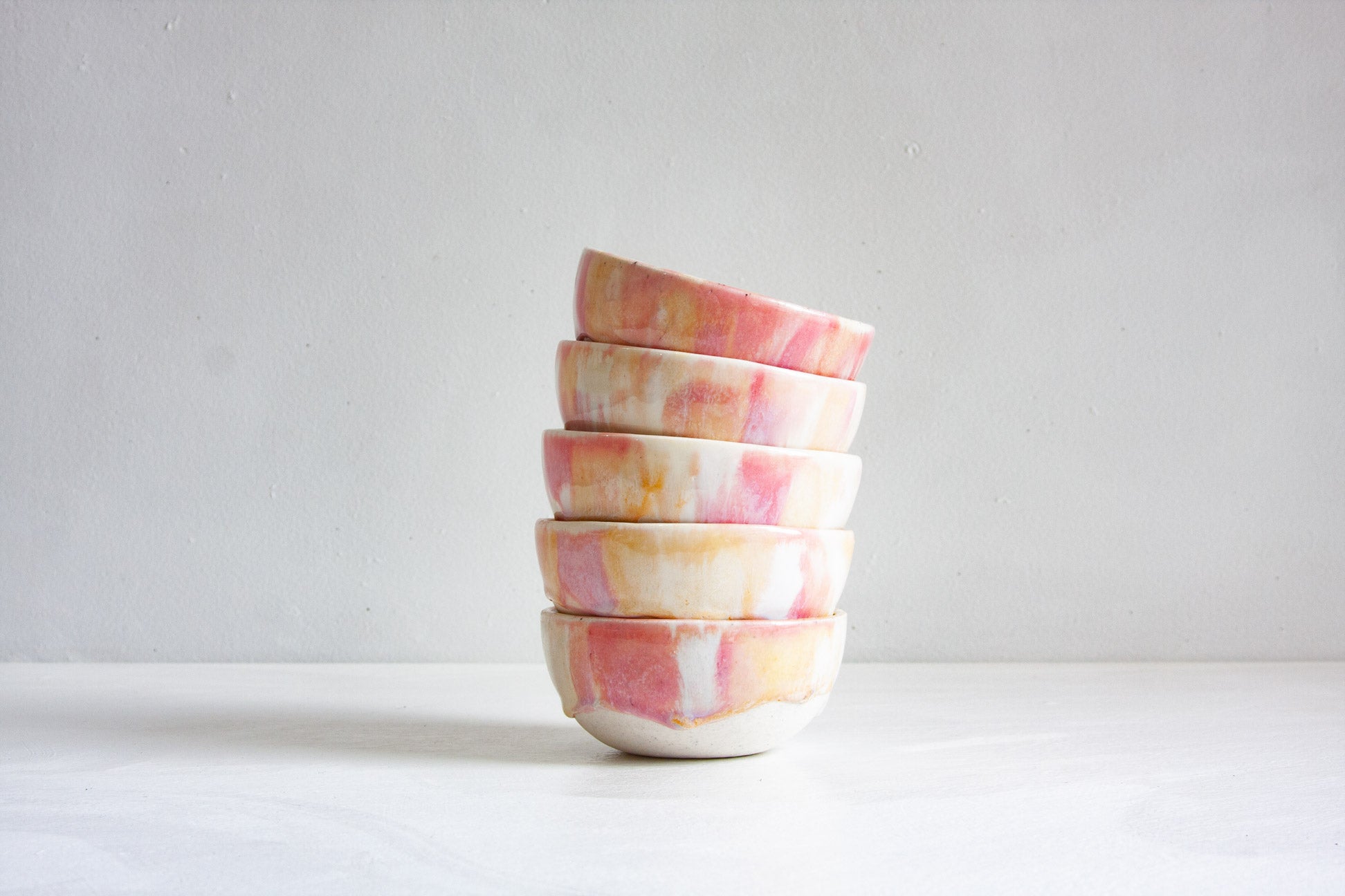 handmade ceramic small pink bowls stacked on top of each other
