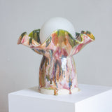 handmade ceramic colourful table lamp on set on a plinth 