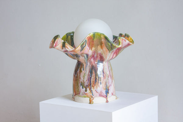 handmade ceramic colourful table lamp on set on a plinth 