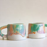 two drippy glazed handmade ceramic mugs.