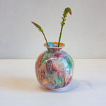 Colourful handmade ceramic moon jar with two flower stems.