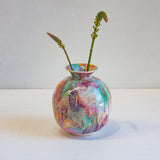 Colourful handmade ceramic moon jar with two flower stems.